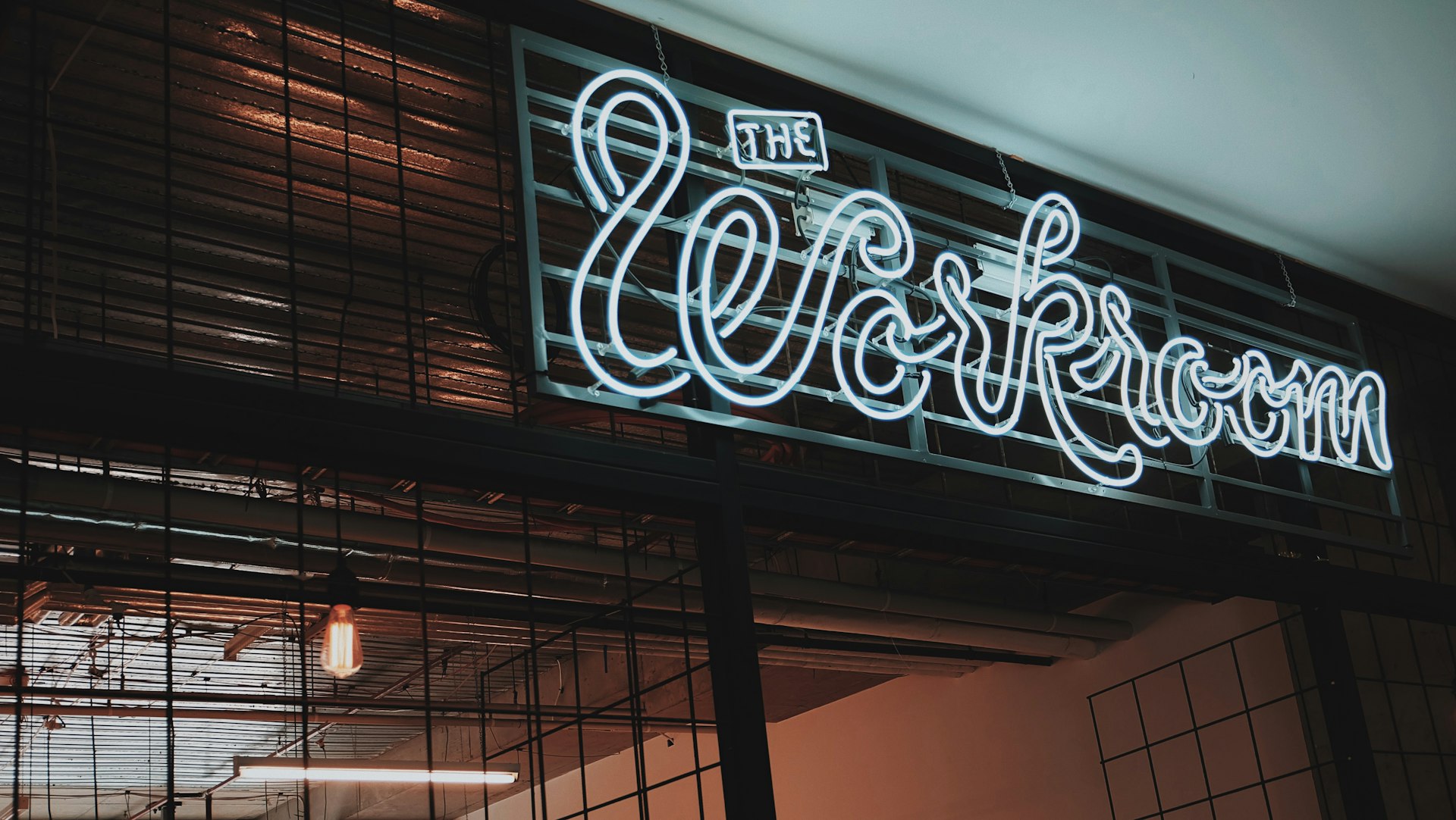 Neon-style meeting room sign with a sleek modern design.